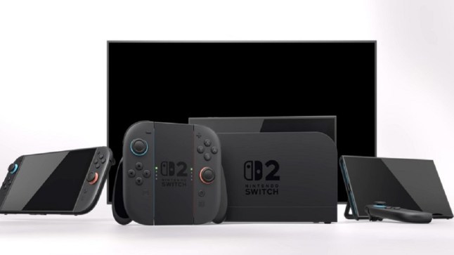 Nintendo Switch 2 console and accessories laid out in a row in front of large TV.